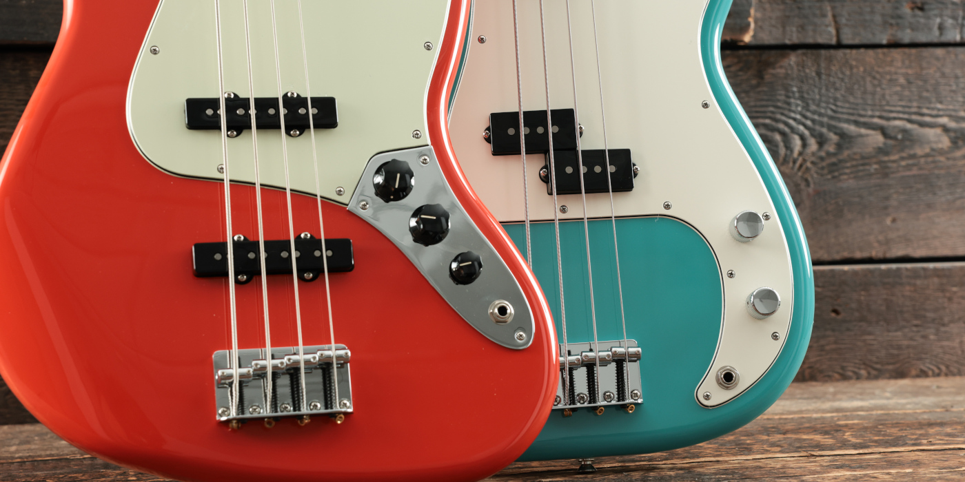 Jazz Bass and P-Bass pickups and controls compared in side by side photo on wooden background