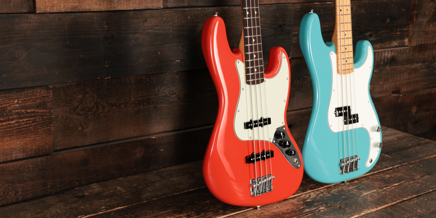 Fender J-Bass and P-Bass next to each other in wooden photography studio