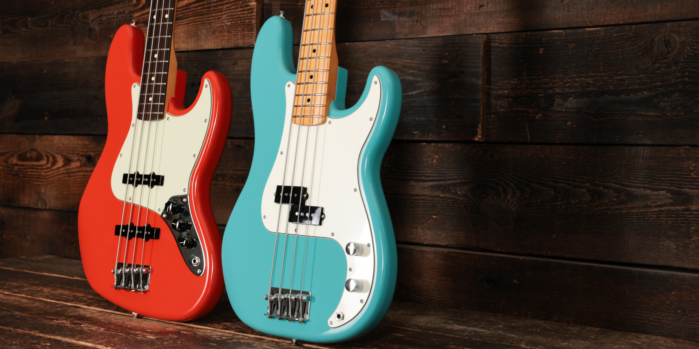 Fender Precision Bass and Jazz Bass bodies side by side on wooden background