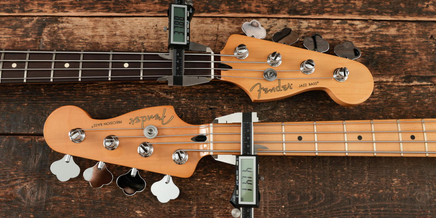 Fender Precision Bass and Jazz Bass necks side by side with tools showing the nut width of each in millimetres
