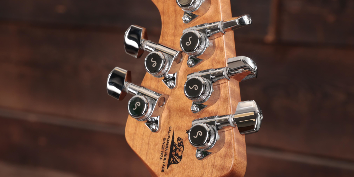 A photo showing the back of a Music Man Luke guitar headstock fitted with locking tuners