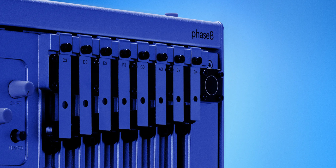 A lifestyle photo of the Korg Phase 8 acoustic synth on a blue background