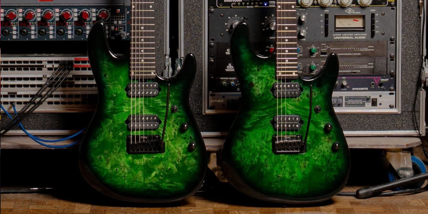 A lifestyle photo of two Sterling by Music Man Jason Richardson signature Cutlass guitars in Kokiri Forest