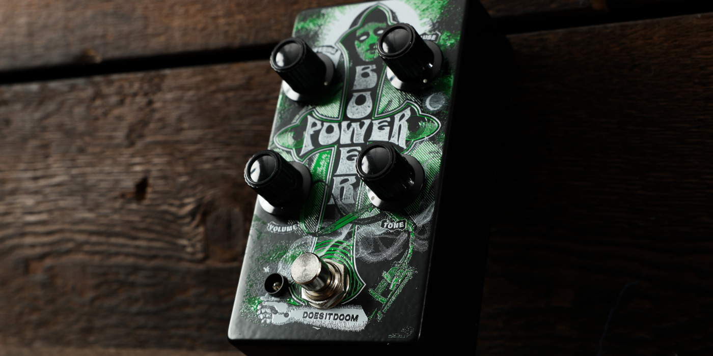 A photo of the Does It Doom Bower Power pedal at an angle against a wooden background