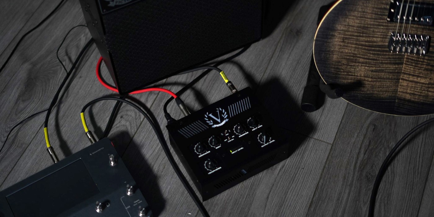 A photo of the Victory PowerValve 200 on a floor set up with a Neural Quad Cortex and guitar cab