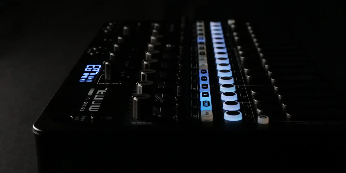 A dark moody photo of the Sonicware Deconstruct Minimal compact groovebox with illuminated buttons