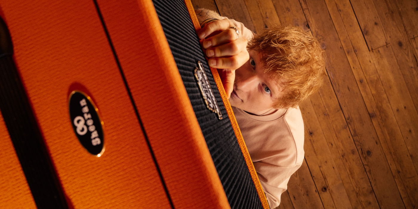 A lifestyle photo showing Ed Sheeran gazing up at his signature Orange Outlowd ES100 acoustic amp