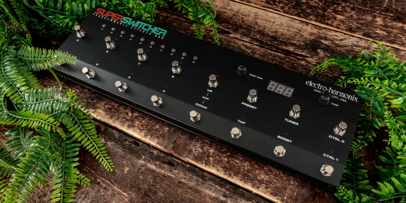 The Electro-Harmonix Super Switcher on a wooden surface surrounded by foliage
