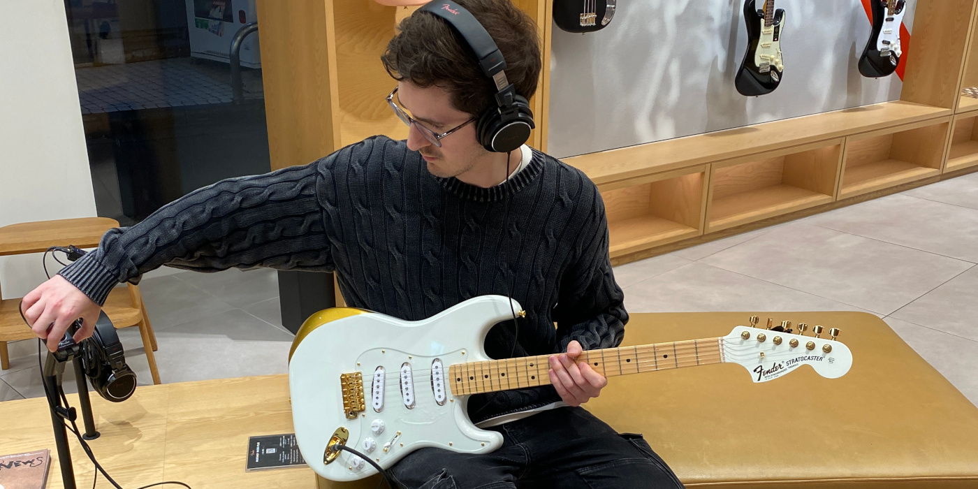 A man trying out the Fender Ken Experiment 1 signature Stratocaster in the Fender Flagship Tokyo shop