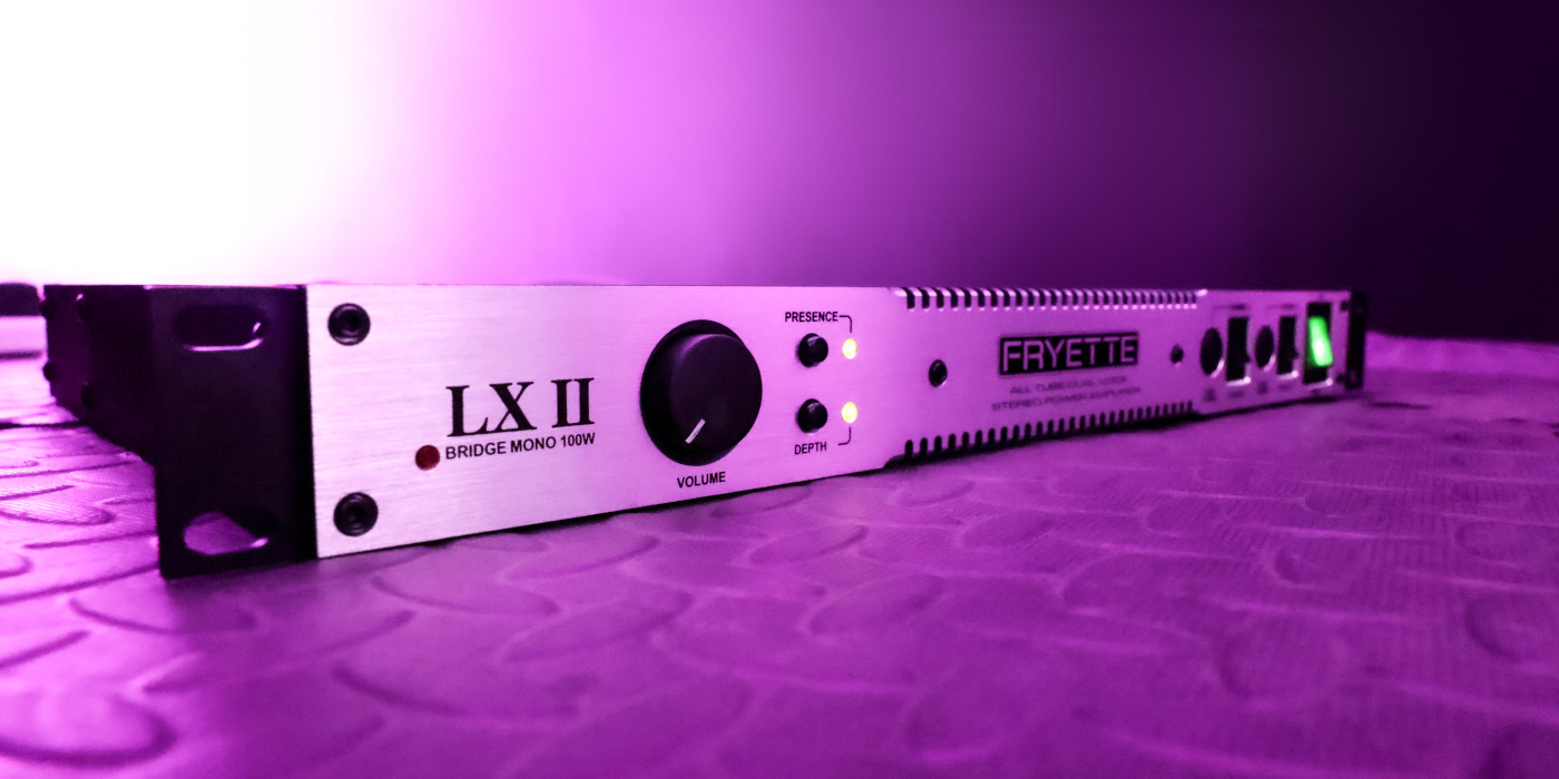 An angled photo of the front of a Fryette LX II stero power amp against a neon lit purple background