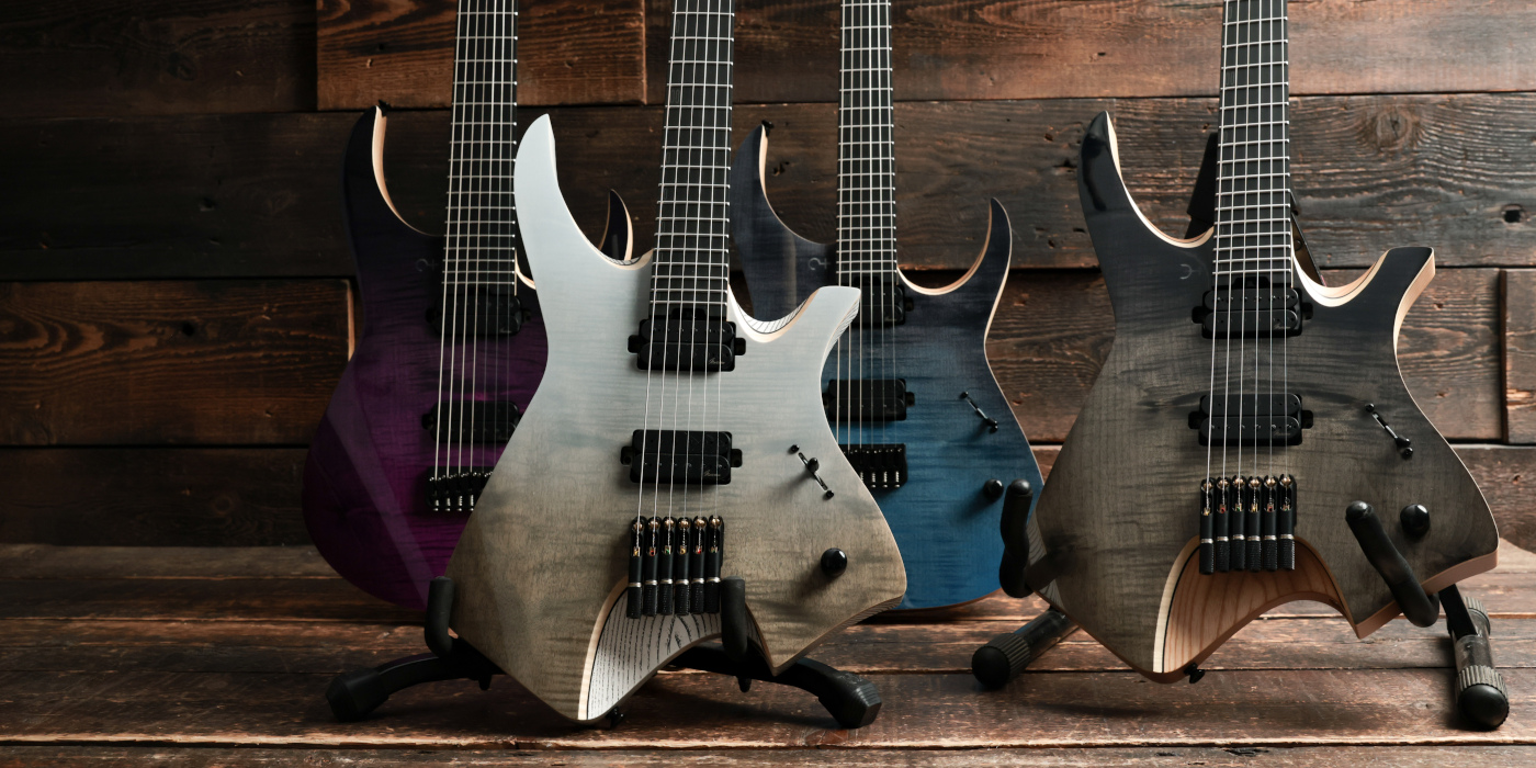 Infinia Ceres and Neptune guitars on stands against a wooden background
