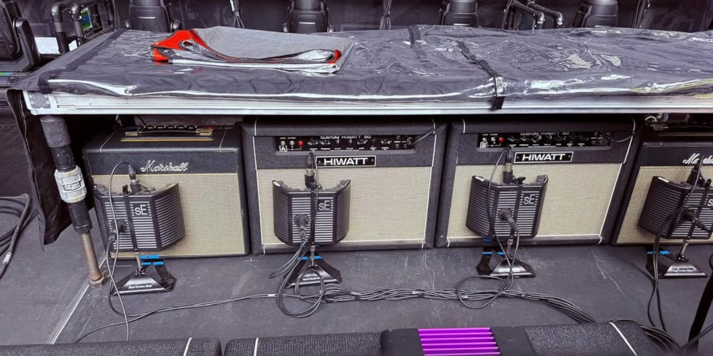 A photo of various Marshall and Hiwatt guitar amps mic'd up on the Oasis Live '25 tour