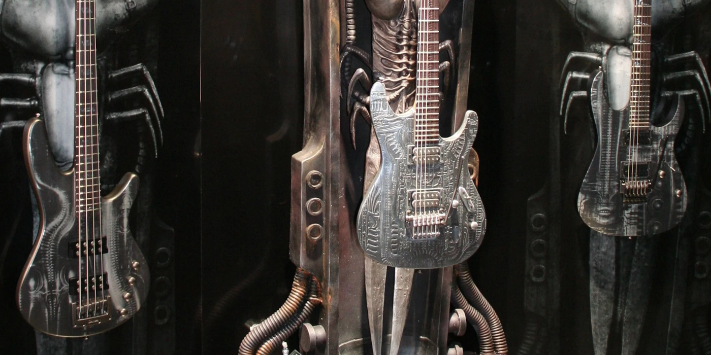 A collection of Ibanez H.R. Giger guitars on a display