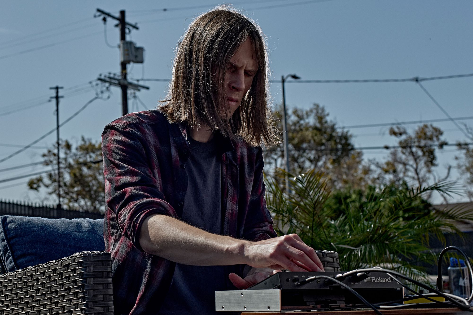 A Roland representative playing the new Roland Jupiter-08 outside on a nice sunny day in America.
