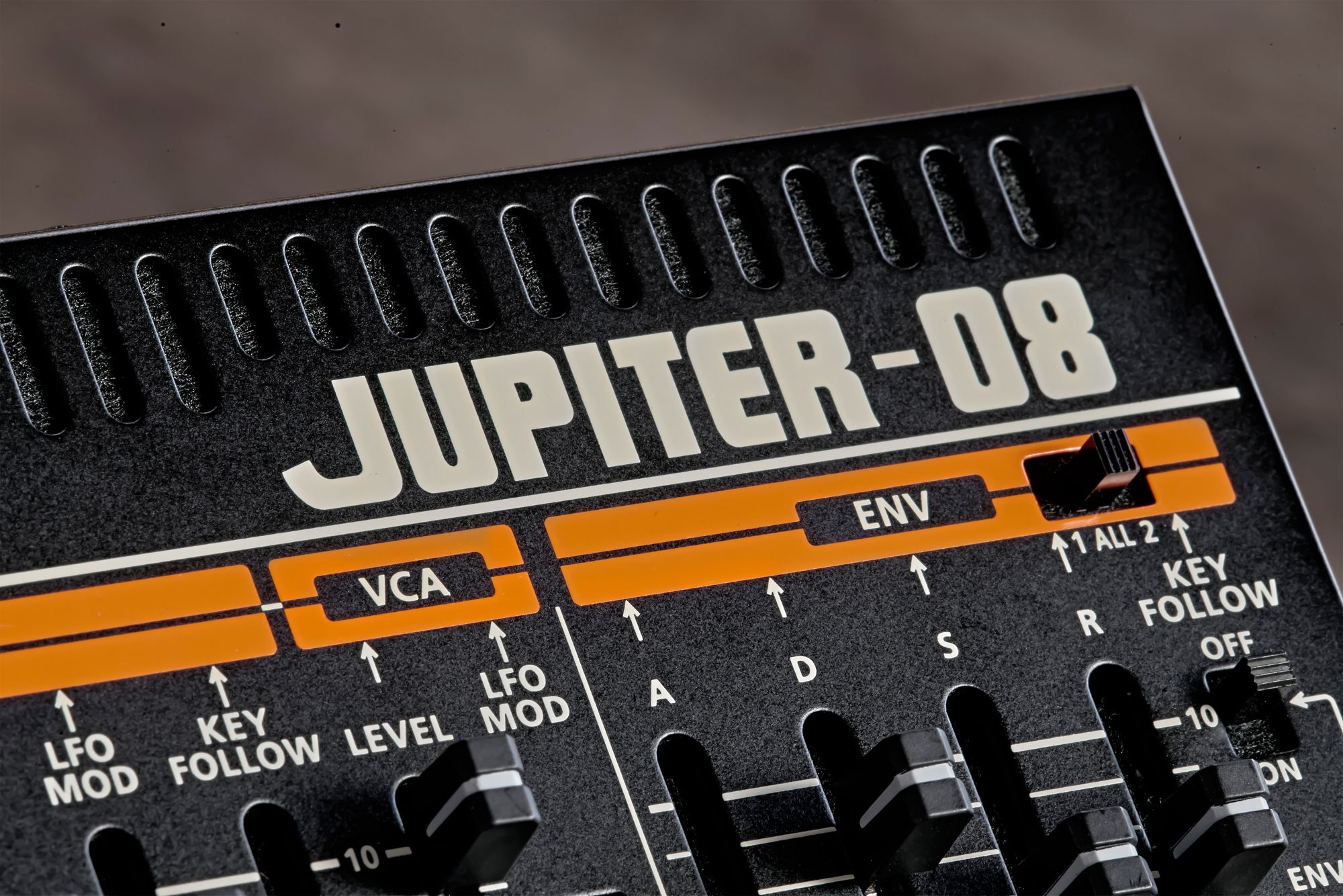 Close up of the Roland Jupiter-08 logo with the duel ENV section and cooling radiator.
