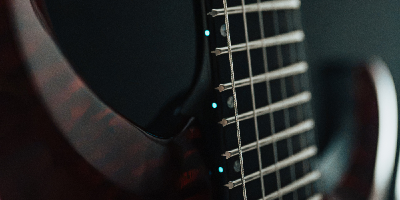 Glowing Luminlay side dots on a guitar neck